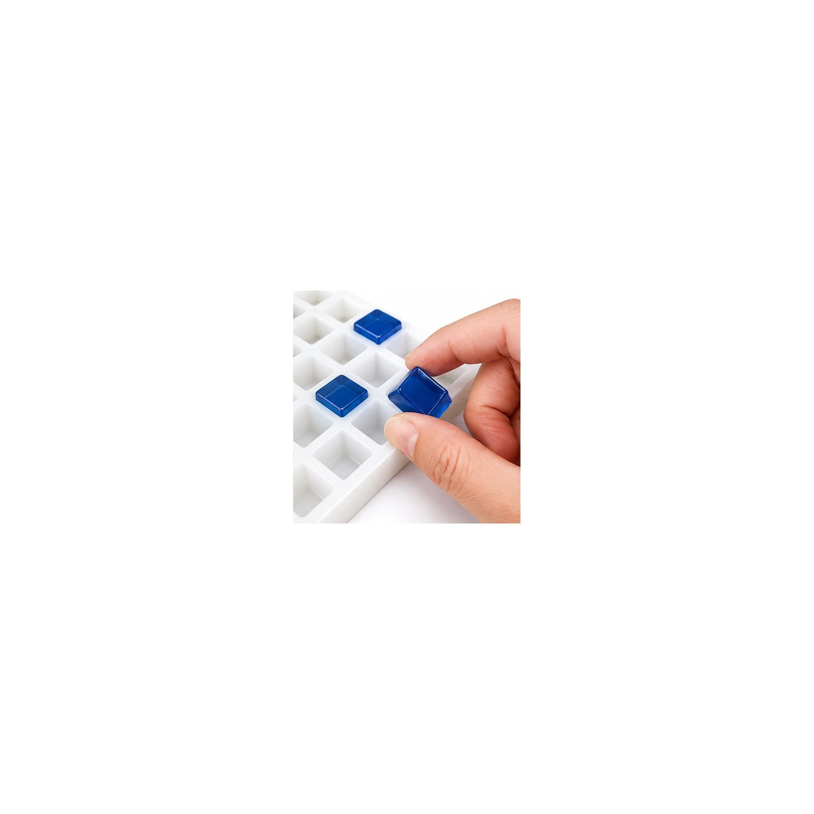 Hand demolding a finished gummy from a flexible commercial silicone gummy mold